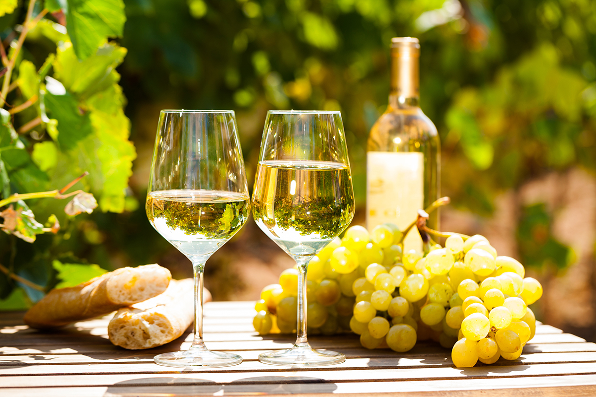 Glass,Of,White,Wine,Grapes,And,Bread,On,Table,In